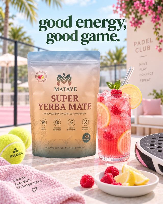 A stand-up pouch of Mataye Super Yerba Mate sits on a table outdoors beside a pink drink with raspberries, lemon slices, tennis balls, and a pink towel. The background shows a sunny poolside or beachside setting with palm trees and a sign reading Padel Club.