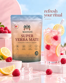 A stand-up pouch of MATAYE Super Yerba Mate sits on a pink platform next to a glass of pink iced drink with raspberries and lemon slices. The background is a soft pink and blue gradient with the text refresh your ritual.